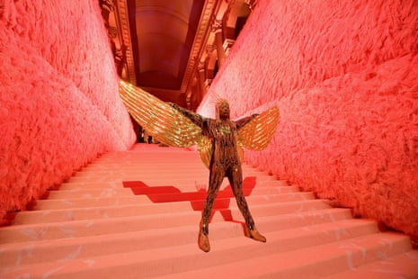 Billy Porter, in gold winged outfit against red background, attends the 2019 Met Gala Celebrating Camp: Notes on Fashion at Metropolitan Museum of Art on May 6 2019 in New York City