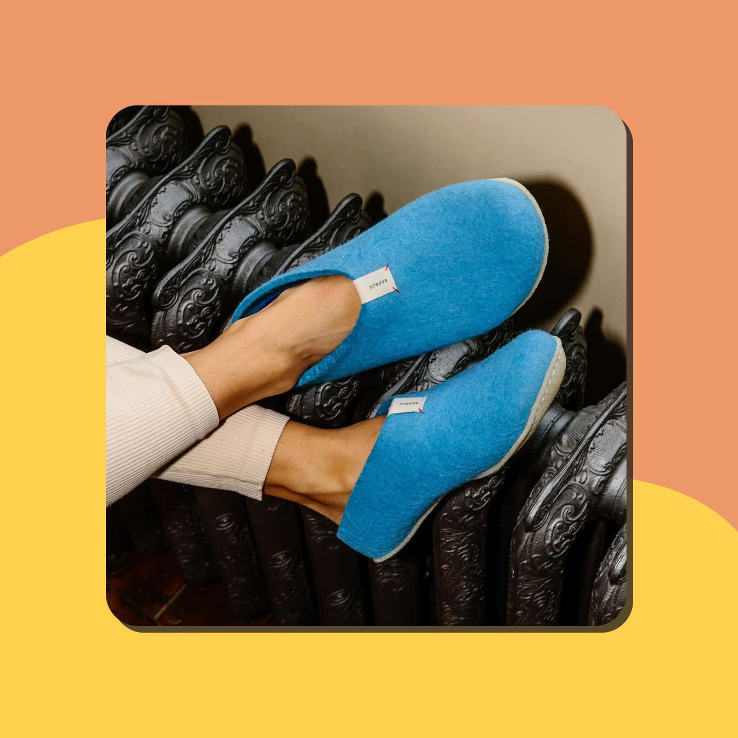 Blue wool slippers being worn by a model 