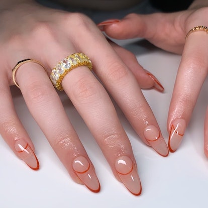 Orange invisible French tip nails are an on-trend Thanksgiving nail design for 2023.