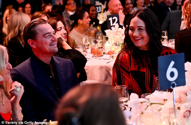 Leonardo DiCaprio at Variety's Power of Women gala, with Meghan laughing at a table behind