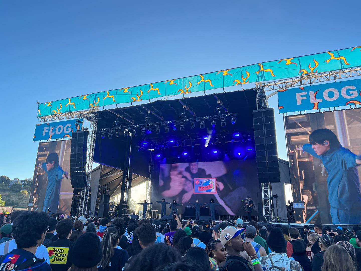 Photo of a large stage with screens overlooking a crowd