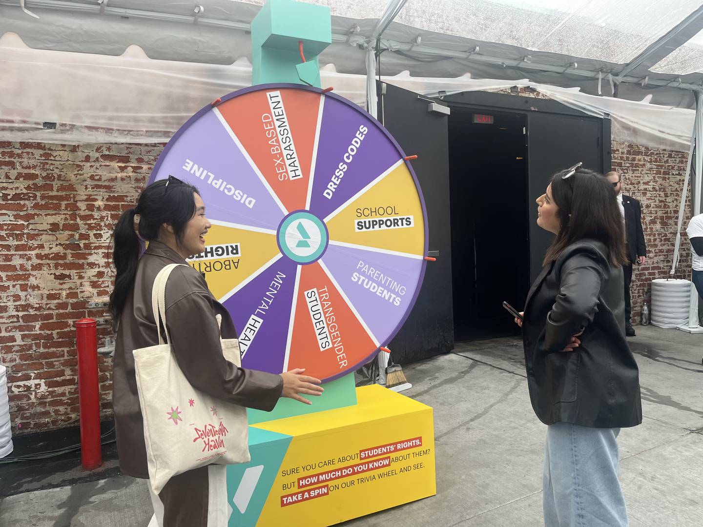 A girl spinning an informational wheel