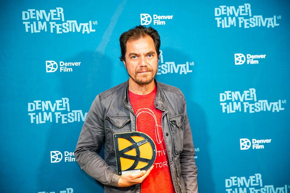 Michael Shannon, Director of the film Eric Larue, accepts the Breakthrough Director Award from Denver Film at the 46th Denver Film Festival.