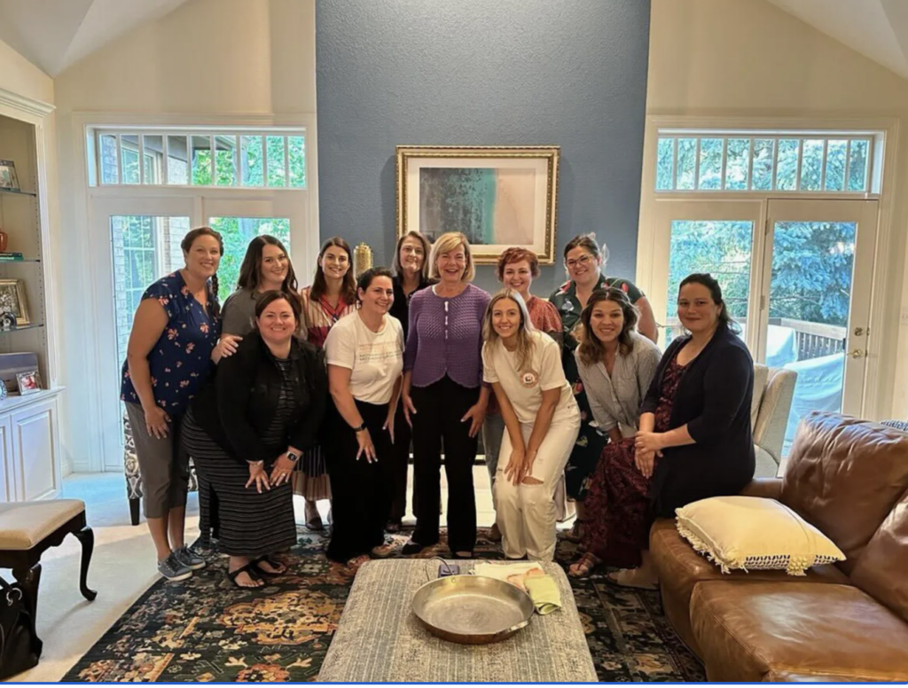 Motherhood for Good members meet with U.S. Sen. Tammy Baldwin at a recent house party in suburban Milwaukee.(Courtesy of Kate Duffy/Motherhood for Good)