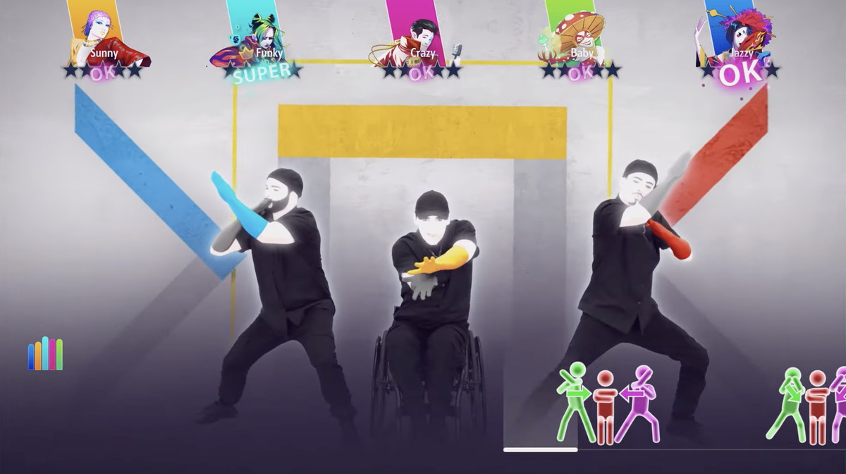 An image of three characters in Just Dance. The one in the middle is dancing while sitting in a wheel chair. He’s reaching and twisting his hands out to the beat of the song.