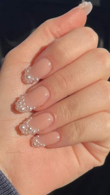 Pearl French Tip: If you are the kind of bride who wants to make a statement, french tip with embellished pearl jewel will make a classy yet striking manicure statement.