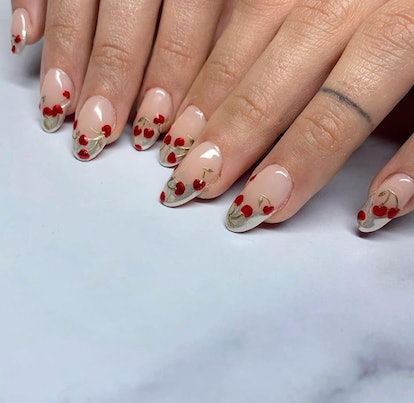 Metallic micro cherry nail art designs are on-trend for Sagittarius season 2023.