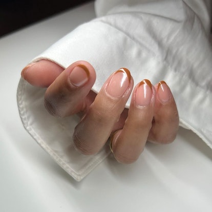 A milk chocolate micro French manicure is an on-trend Thanksgiving nail design for 2023.