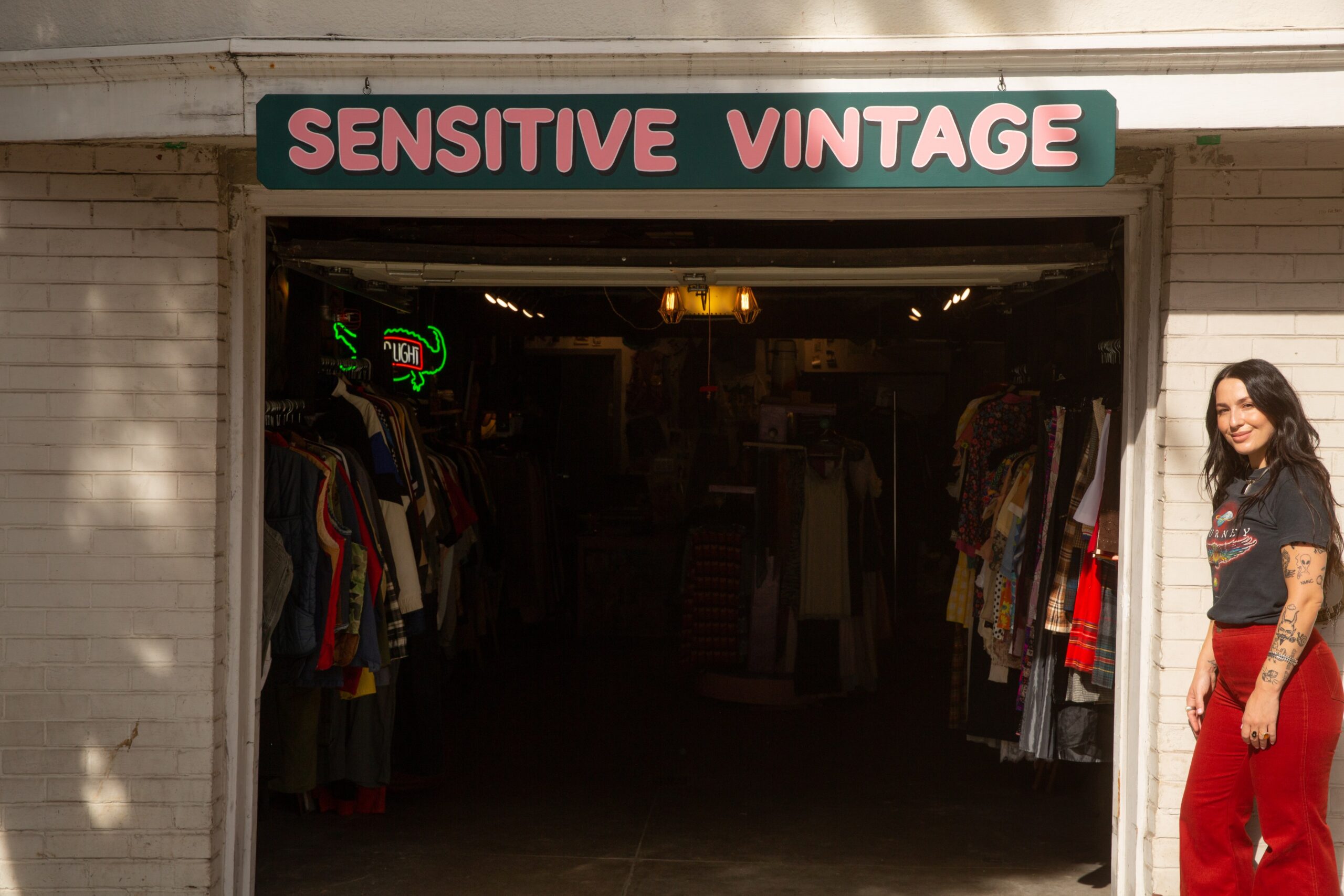 Sensitive Vintage proprietor Sivan Peleg stands in front of the open garage door to her pop-up vintage fashion boutique in the Mission District. 