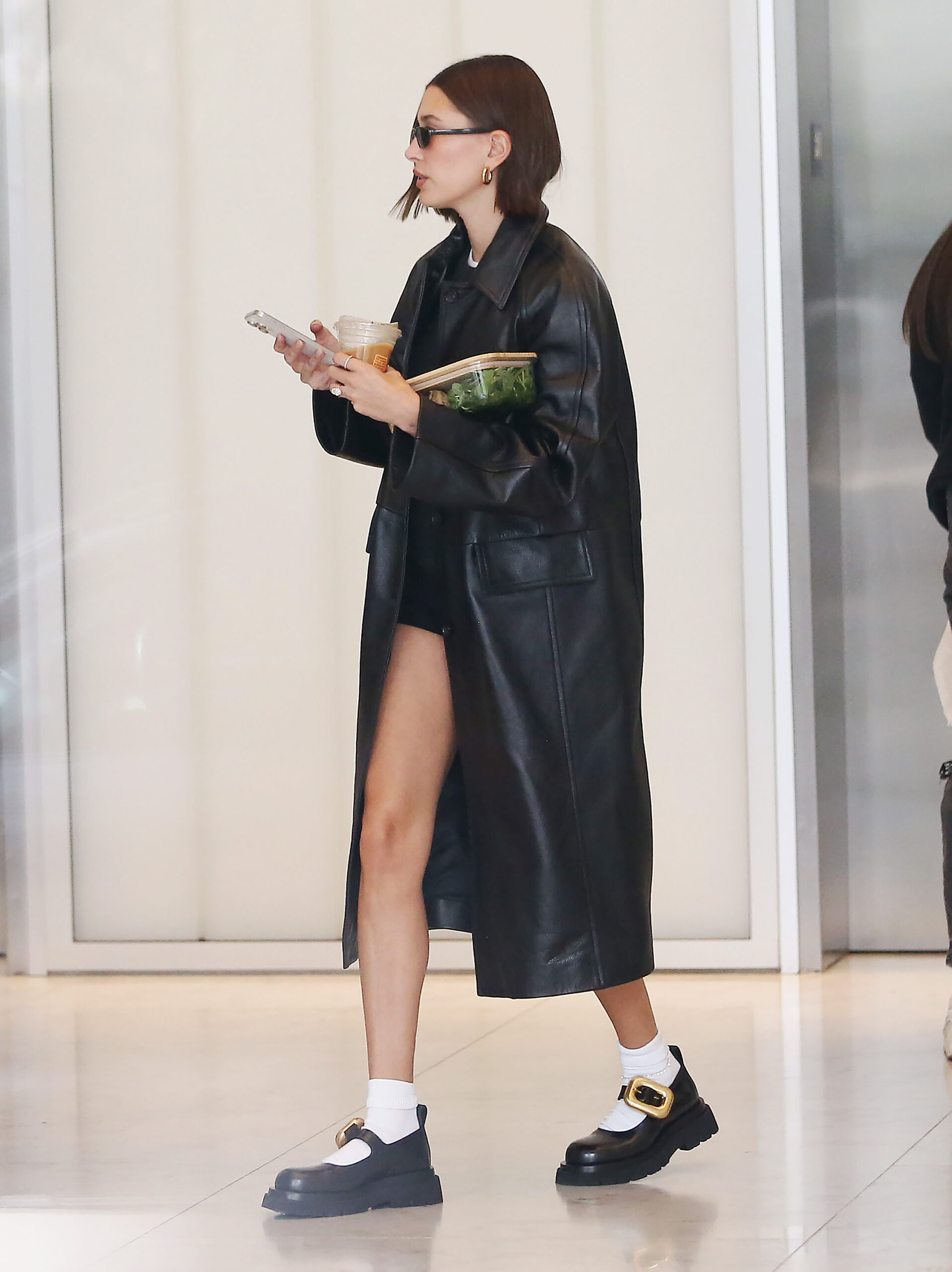 Hailey opted for a long black trench coat