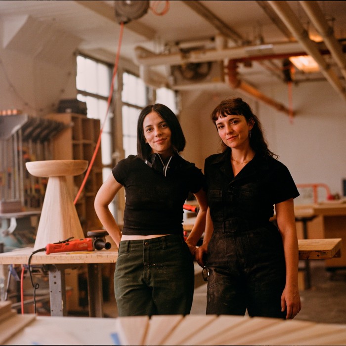 two young women in their woodworking studio