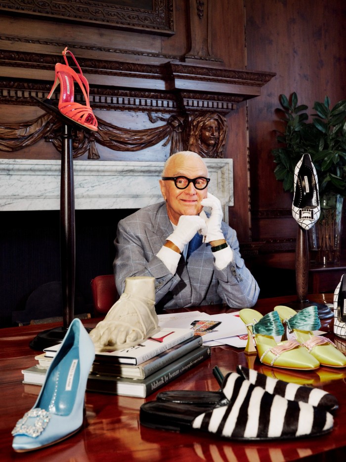 Manolo Blahnik at his company’s new headquarters at 31 Old Burlington Street, surrounded by shoes and sketches. He wears a suit by Anderson & Sheppard