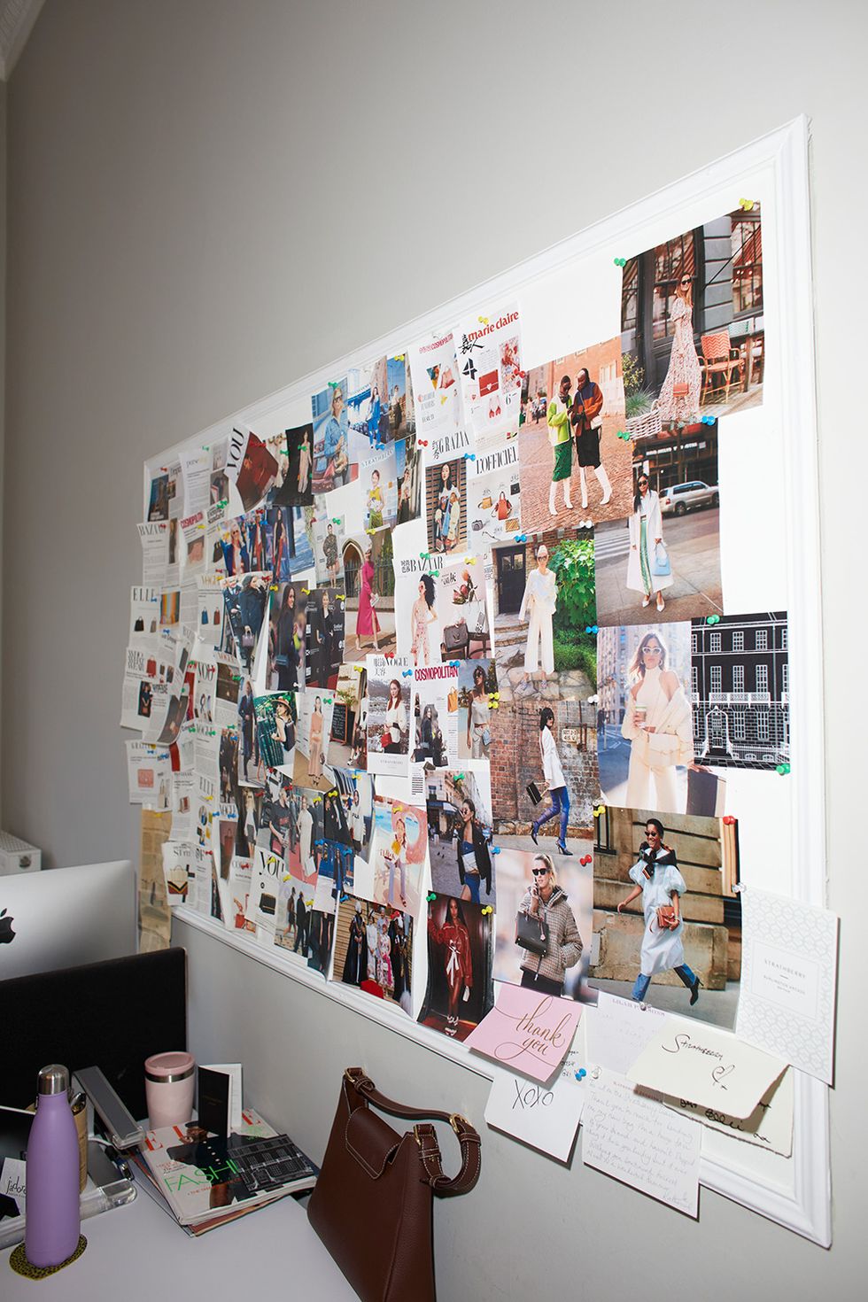 a wall with pictures and posters on it