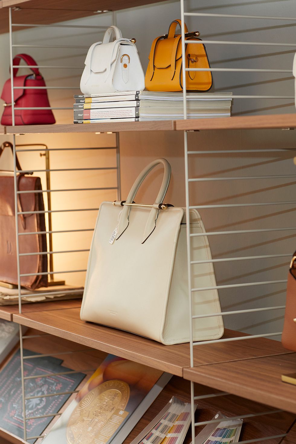 a group of strathberry bags on a shelf