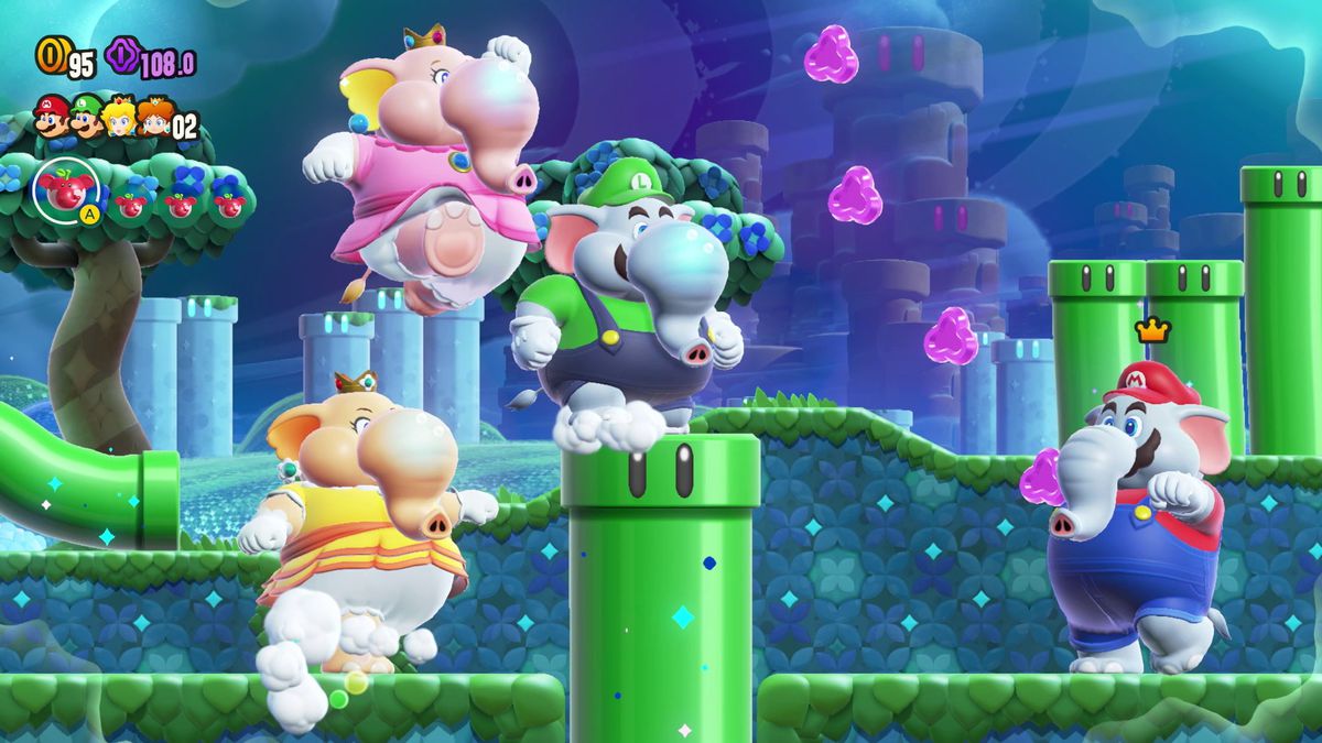 Daisy, Peach, Luigi, and Mario, in elephant form, run through a pipe-filled level in Super Mario Bros. Wonder