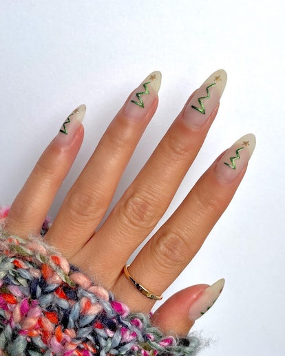 For a simple Christmas nail design for the 2023 holiday season, abstract Christmas tree nail designs...