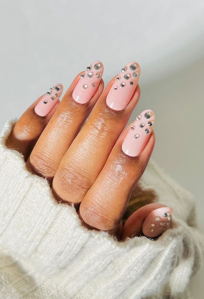 Bubble bath nails with round nail rhinestones are on-trend for New Year's Eve 2023 nails.