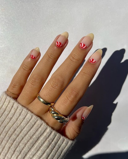 For a simple Christmas nail design for the 2023 holiday season, a peppermint half moon manicure is f...