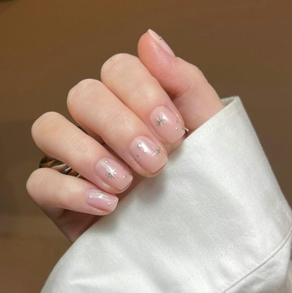 Minimal silver star nail art is a simple & short manicure design idea for New Year's Eve 2023 nails.