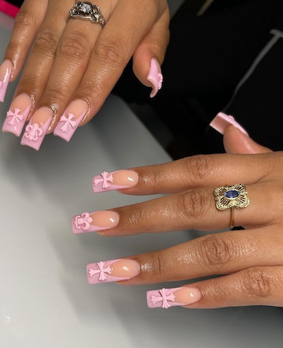 Polygel nails with pink French tips & 3D cross nail art charms.