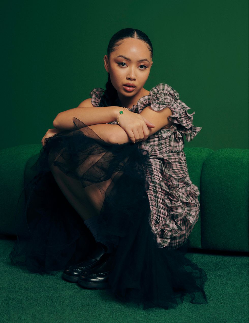 a woman sitting on a green couch