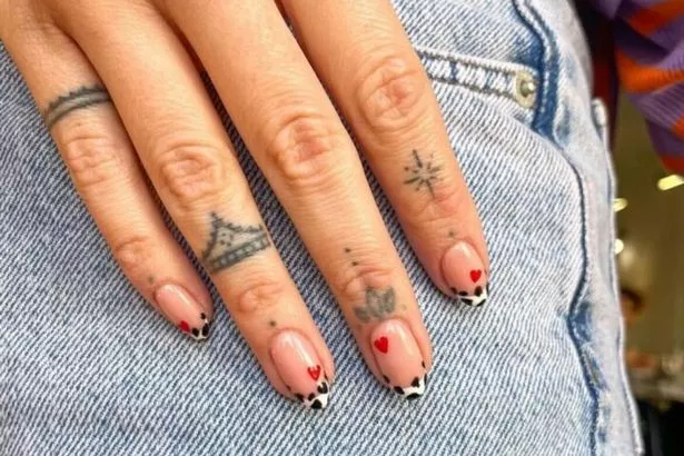Combine a print you love with some V-day hearts for a unique nail design