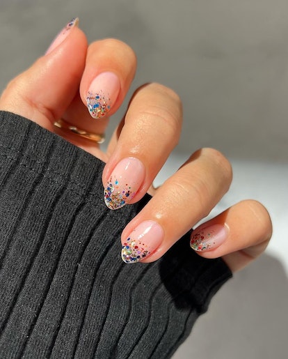 Colorful glitter French tips are a trendy French manicure idea for 2024.