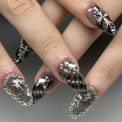 Edgy silver nail jewelry is on-trend for 2024's Aquarius season.