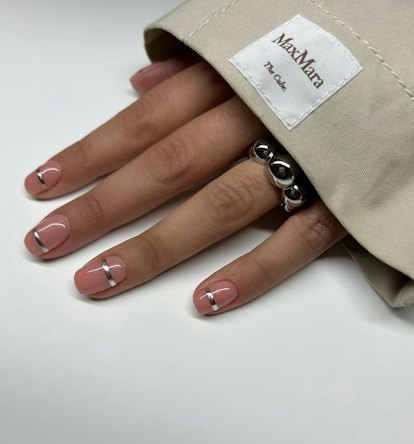 Minimal silver nail cuffs are on-trend for 2024's Aquarius season.