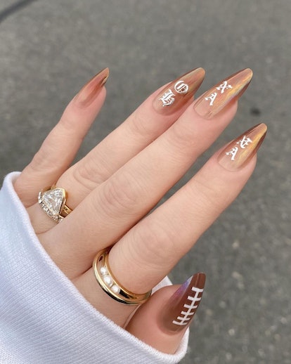 Football lace art atop cognac chrome nails are on-trend for the 2024 Super Bowl.