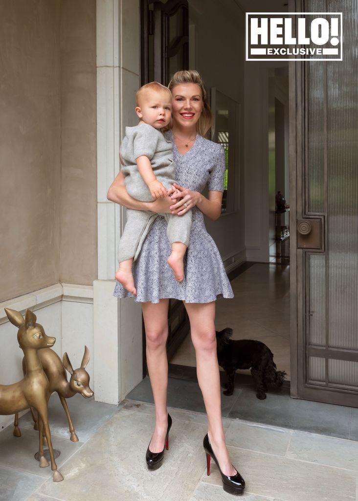 Tyler Ellis holding son Fitz Harold in doorway of LA home