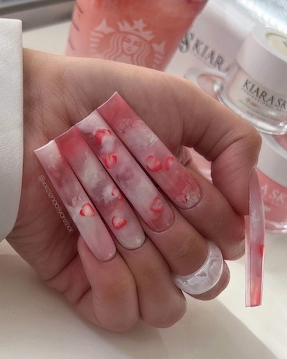 Extra-long Pink Drink-inspired nails are on-trend for 2024.