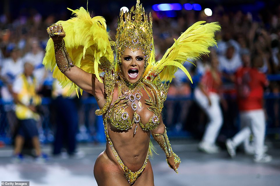 Thousands of performers danced their way down a Rio de Janeiro avenue on Sunday as the Brazilian beach city's famed carnival parades got into full swing. Pictured: Queen of drums, Viviane Araujo of Salgueiro performs during the carnival