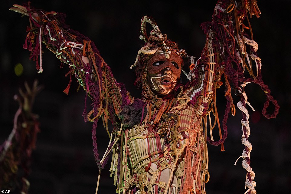A performer from the Unidos da Tijuca samba school in an elaborate costume performs on Monday morning