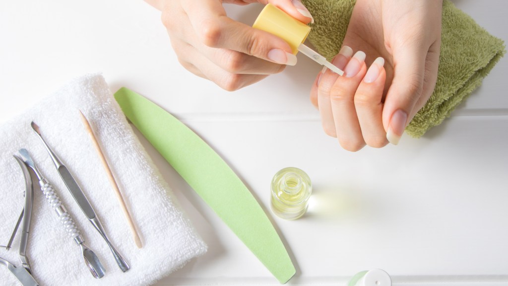 woman doing dip nails at home, prepping nails