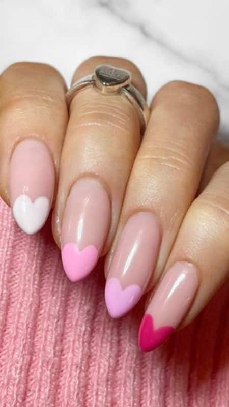 Pastel Hearts Affair: Charming pastel pink nails graced with white and playful pink hearts, embodying a sweet, romantic vibe.