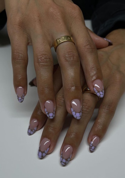 Lilac croc print French tip nails are on-trend.