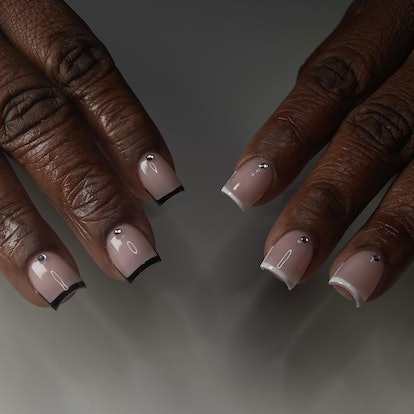 Referee-inspired black and white micro French nails are on-trend for the 2024 Super Bowl.