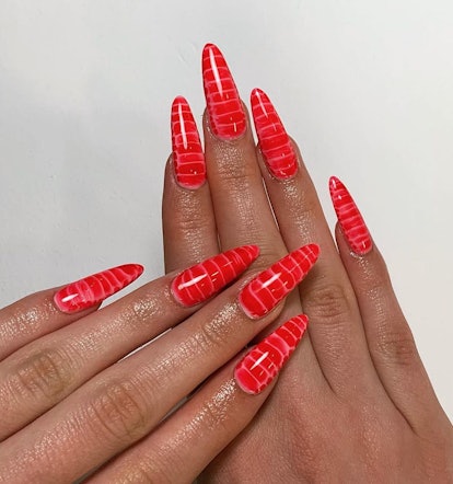 Fire-red croc print manicures are trending for Aries season 2024.