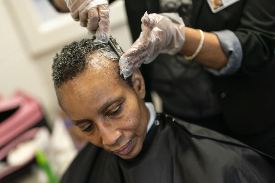 Clarice Booze, a hairstylist volunteer, demonstrates how to dye hair on Tammy Townsend, 56, during a barber and beauty school class on Tuesday, March 12, 2024, at the St Louis County Jail in Clayton.