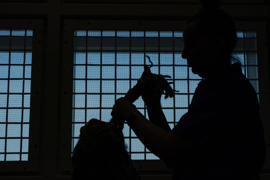 Michelle Lam, 38, works on re-twisting Nysha Nichols’, 28, hair during a barber and beauty school class on Tuesday, March 12, 2024, at the St Louis County Jail in Clayton.