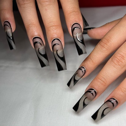 Sheer black nail art matches the 