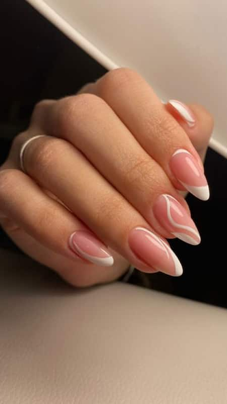 French Twist: Medium-length nails with a modern take on the classic French manicure, featuring a pink base and white tips.