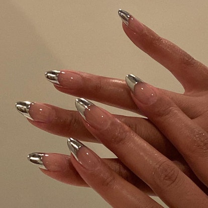 Silver chrome French tip nails match the 