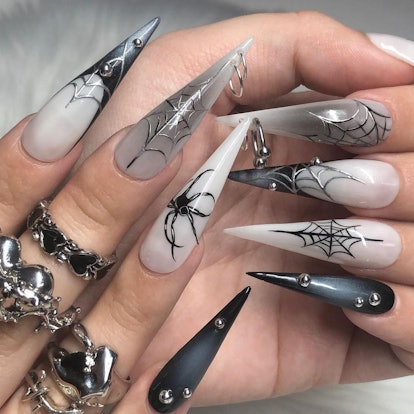 Stiletto nails with spider-inspired designs match the 