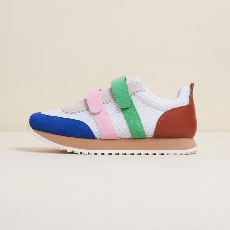 A white sneaker with colorful Velcro straps