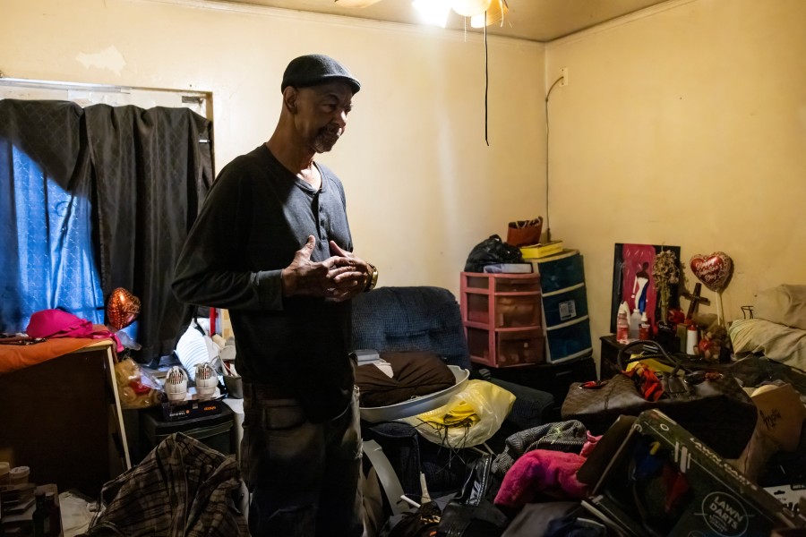Arther Sanders standing in cluttered room