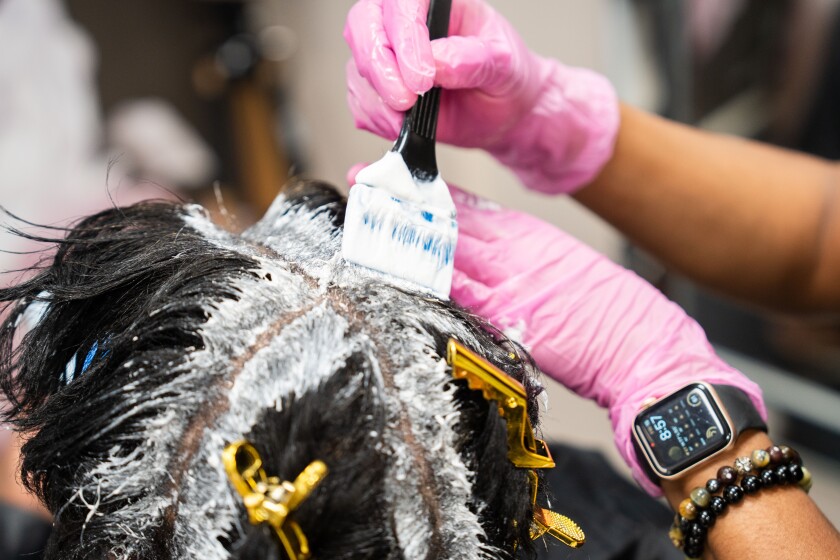 LaQuana Johnson, a cosmetologist and owner of Elite Hair Therapy LLC, applies hair relaxer on her client’s hair at Elite Hair Therapy in the Bronzeville neighborhood, Friday, Sept. 15, 2023. | Pat Nabong/Sun-Times