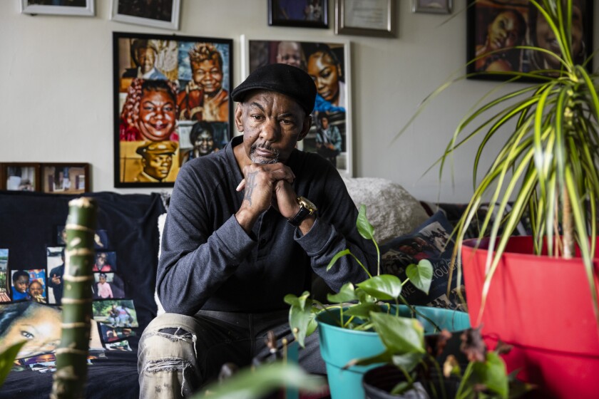 Arther Sanders sits in his living room, surrounded by photos of his wife Sheree Sanders and her plants, which he said she called her “babies,” in their Detroit home, Sunday, March 24, 2024. Sheree Sanders, who died in January, started wearing her hair straight well before she met her future husband in the mid-1990s. She filed a lawsuit after she was diagnosed with uterine cancer in 2019. I Ashlee Rezin/Sun-Times