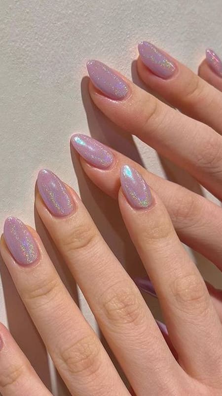 Subtle lavender nails with a holographic sheen offer a simple yet enchanting appearance, perfect for a touch of everyday magic.